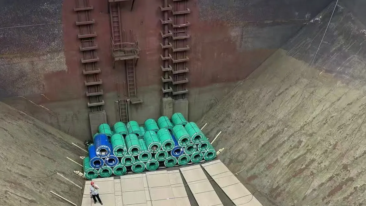 Green and blue wrapped stainless coils stacked in the bulk-carrier hold