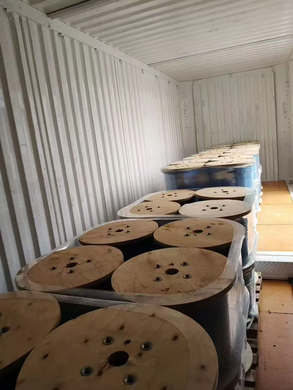 Palletized galvanized wire-rope reels stretch-wrapped inside the container