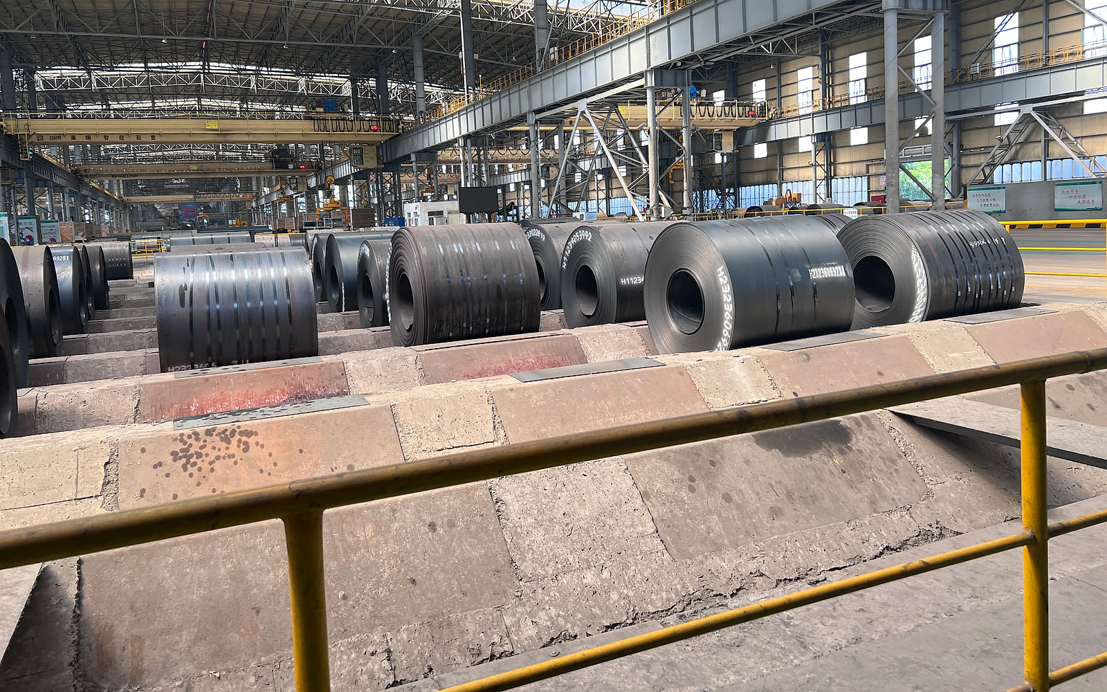Hot-rolled carbon steel coils in a steel mill storage bay